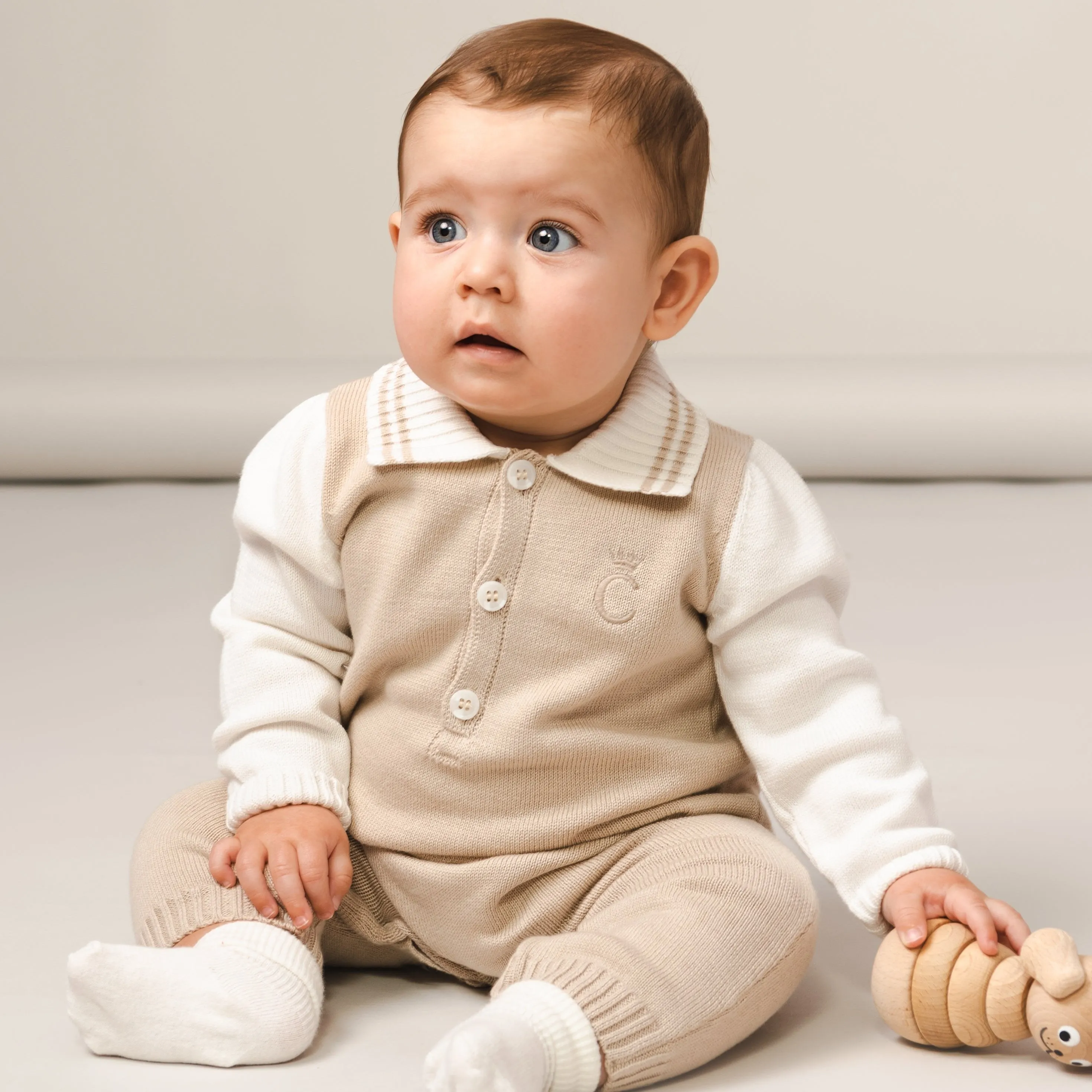 Beige gestrickter Overall für Babyjungen